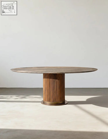 Round wooden dining table with fluted pedestal base and light brown top in murcell oval dining table style