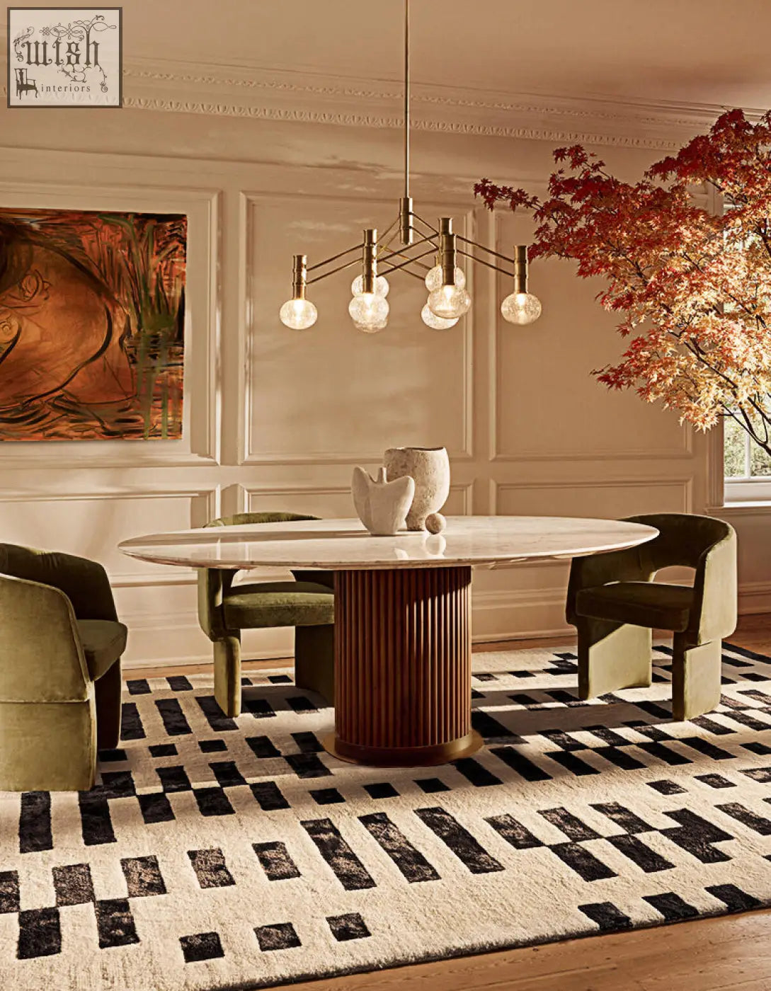 A murcell oval dining table featuring a sleek oval marble top and a reddish brown fluted pedestal base perfect for dining rooms