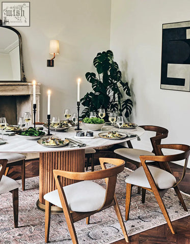 Marble-top murcell oval dining table with fluted wooden base and matching mid-century modern chairs with white seats