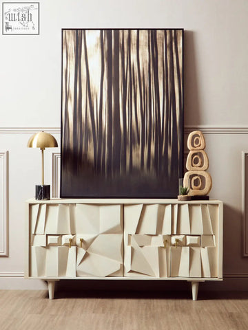 Murdoch brass table lamp with black marble base shown on cream geometric sideboard with gold-tone hardware