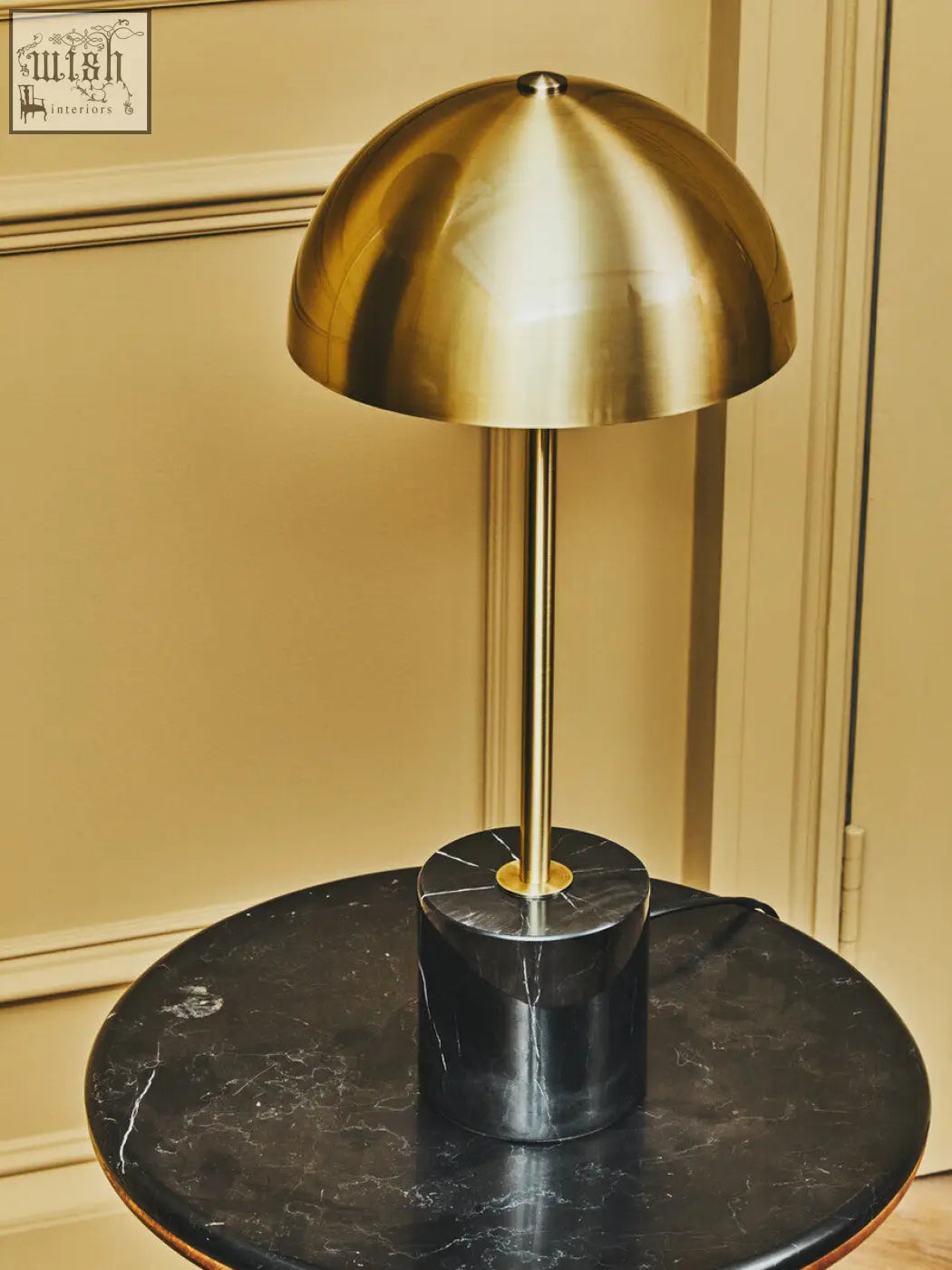 Murdoch brushed brass table lamp with a sleek brass dome and black marble base for stylish lighting