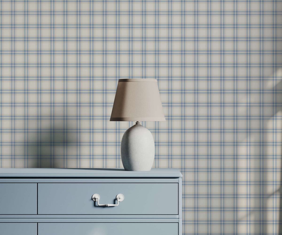 Murray sleek off-white ceramic table lamp with beige fabric shade on light blue dresser with plaid wallpaper background