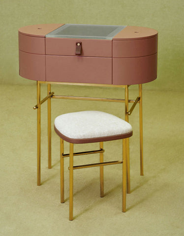 A sleek blush pink muskoka dressing table set with glass top and gold tone metal legs for stylish vanity use