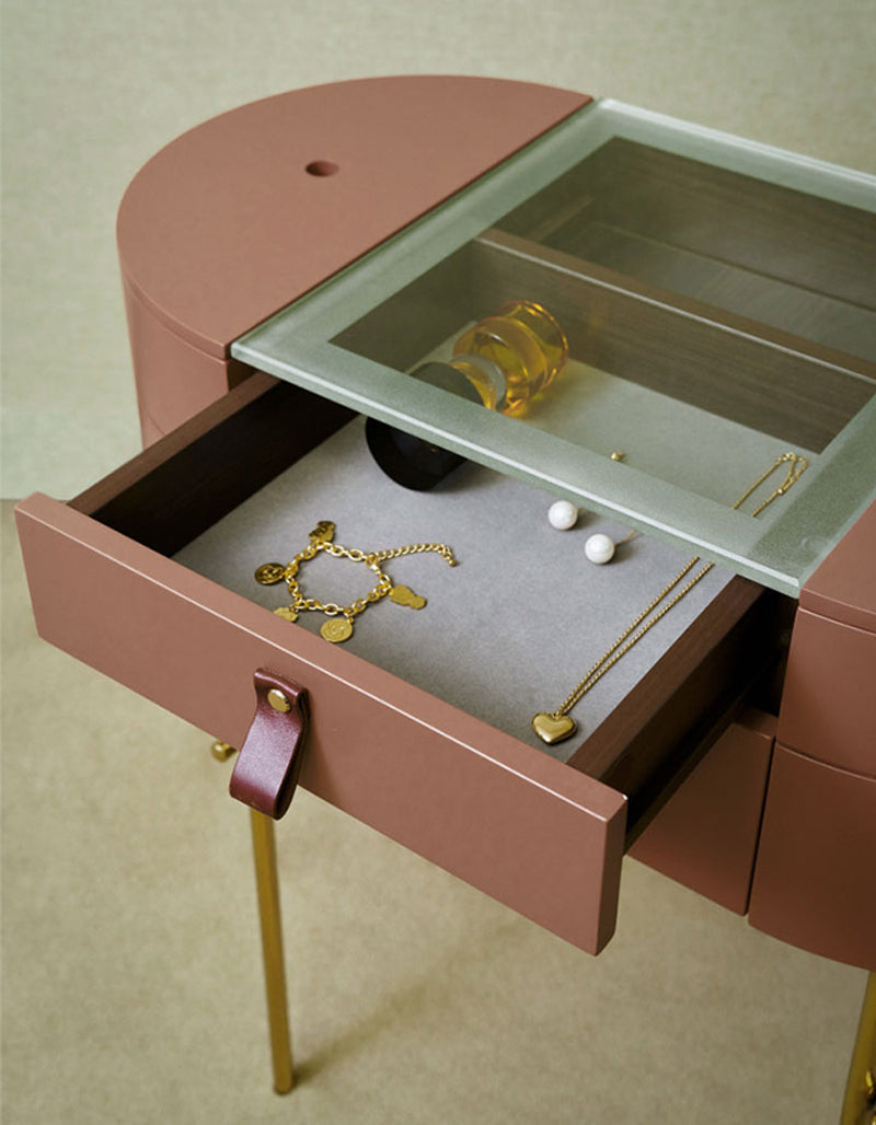 Sleek rose gold muskoka dressing table set with glass top jewelry cabinet, leather pull handle, and golden legs
