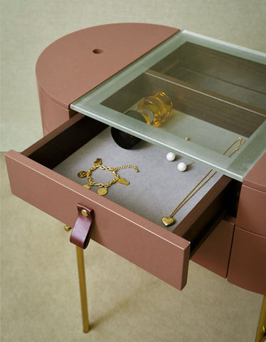 Sleek rose gold muskoka dressing table set with glass top jewelry cabinet, leather pull handle, and golden legs