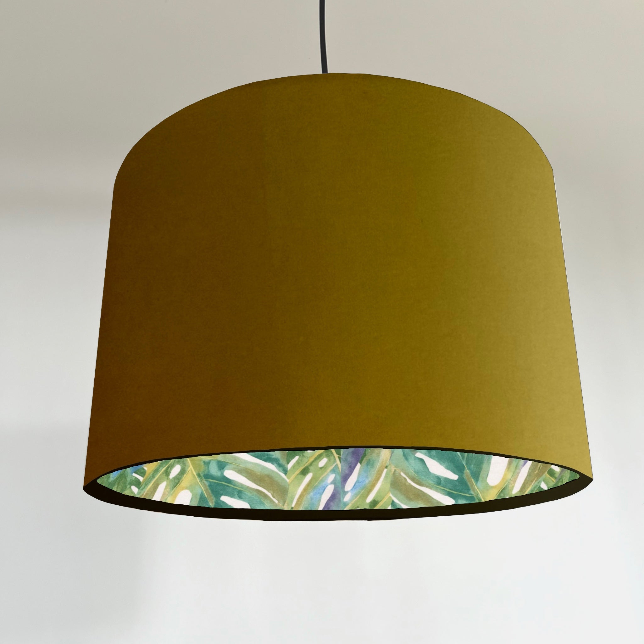 Mustard velvet double sided drum ceiling light shade with olive green velvet and tropical leaf pattern lining