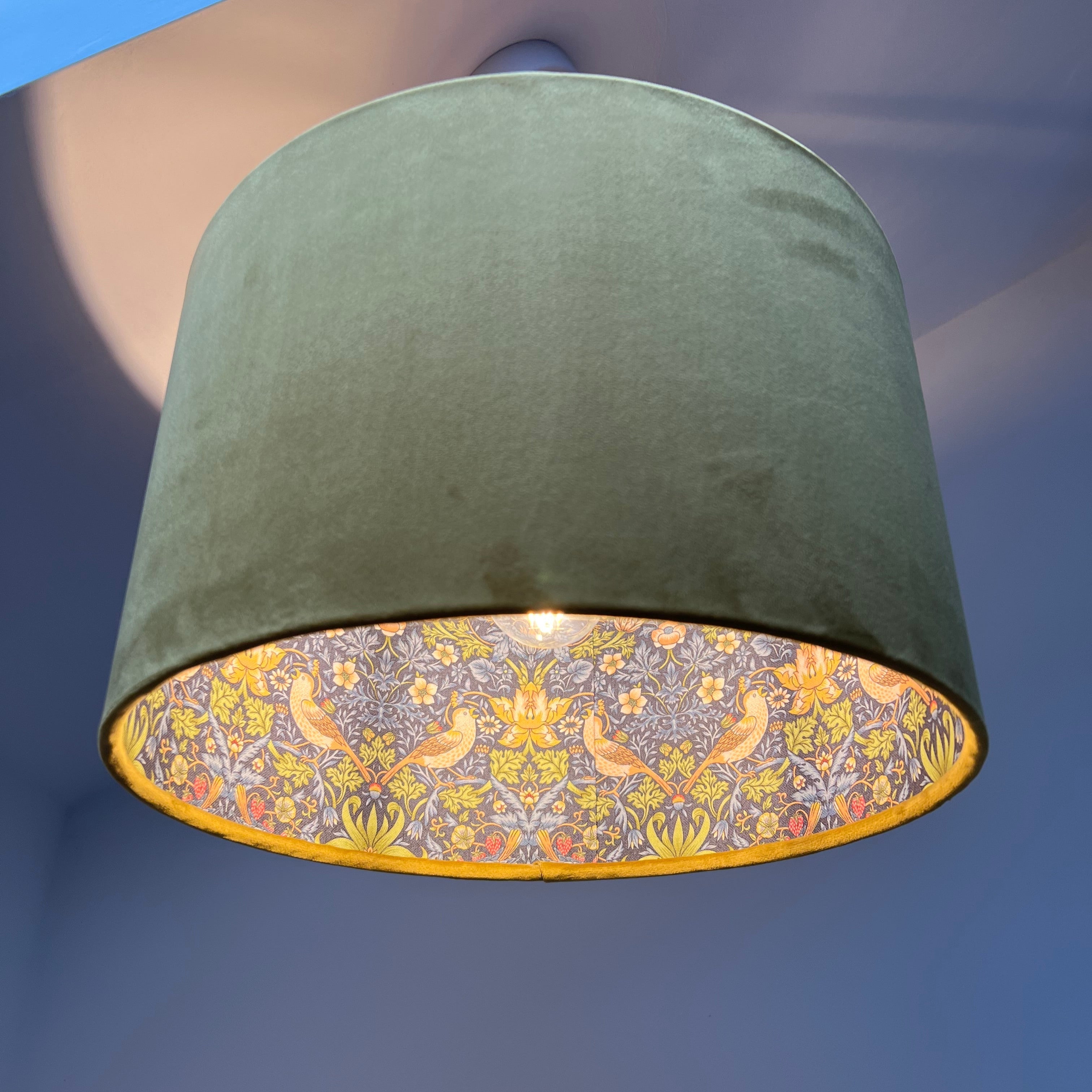 Cylindrical mustard velvet double sided ceiling light shade with navy strawberry thief bird and floral pattern interior
