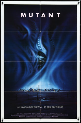 Dark blue menacing mutant with glowing eyes and sharp teeth dominates the mutant 1985 original us movie poster design