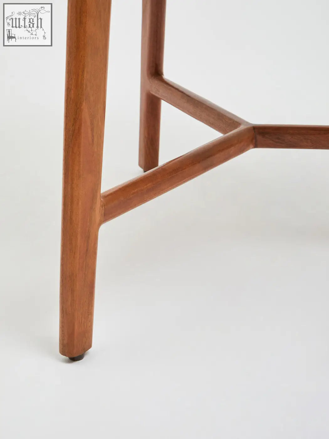 Close-up of mid-century modern wooden legs and triangular acacia wood frame of myan white marble round side table