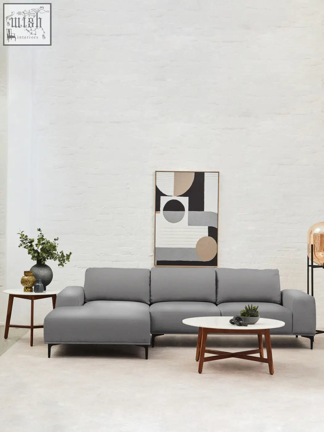 Gray sectional sofa with clean lines paired with myan acacia wood and white marble round side table