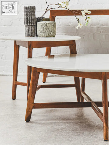 Two mid-century modern myan acacia wood side tables with white marble round tops and warm wooden legs