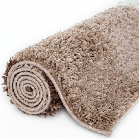 A plush beige shaggy myshaggy geometric brown rug with soft textured surface and neatly rolled edges
