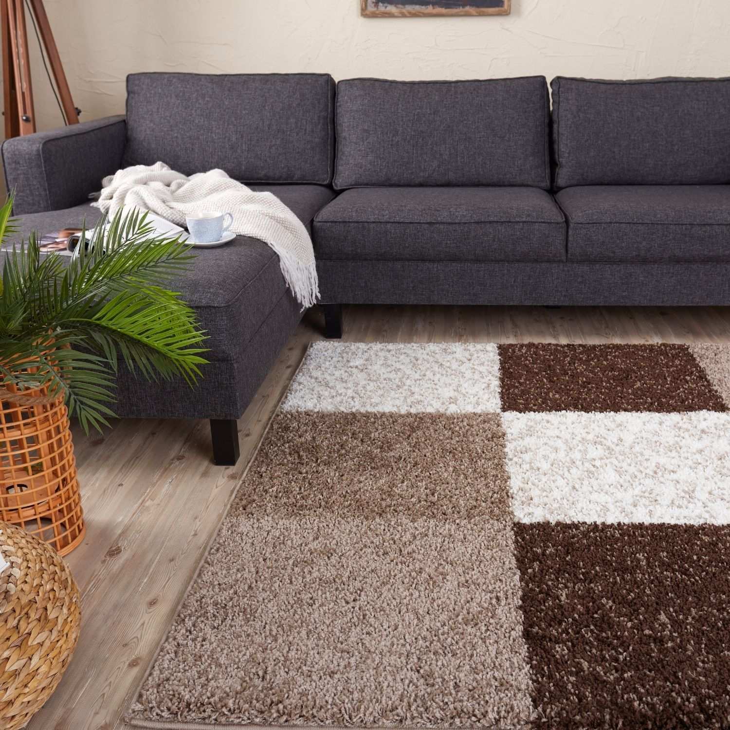 A plush shaggy textured myshaggy geometric brown rug in shades of brown and white with a patchwork design