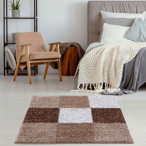 A plush rectangular myshaggy geometric brown rug with a patchwork design in shades of brown and white