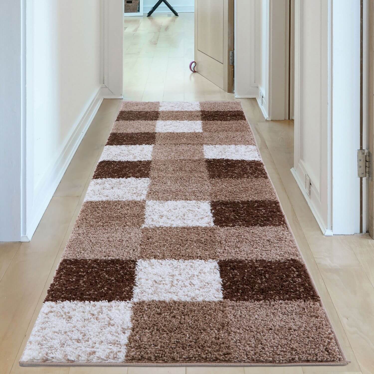 A plush rectangular myshaggy geometric brown rug with a patchwork design of cream and brown squares