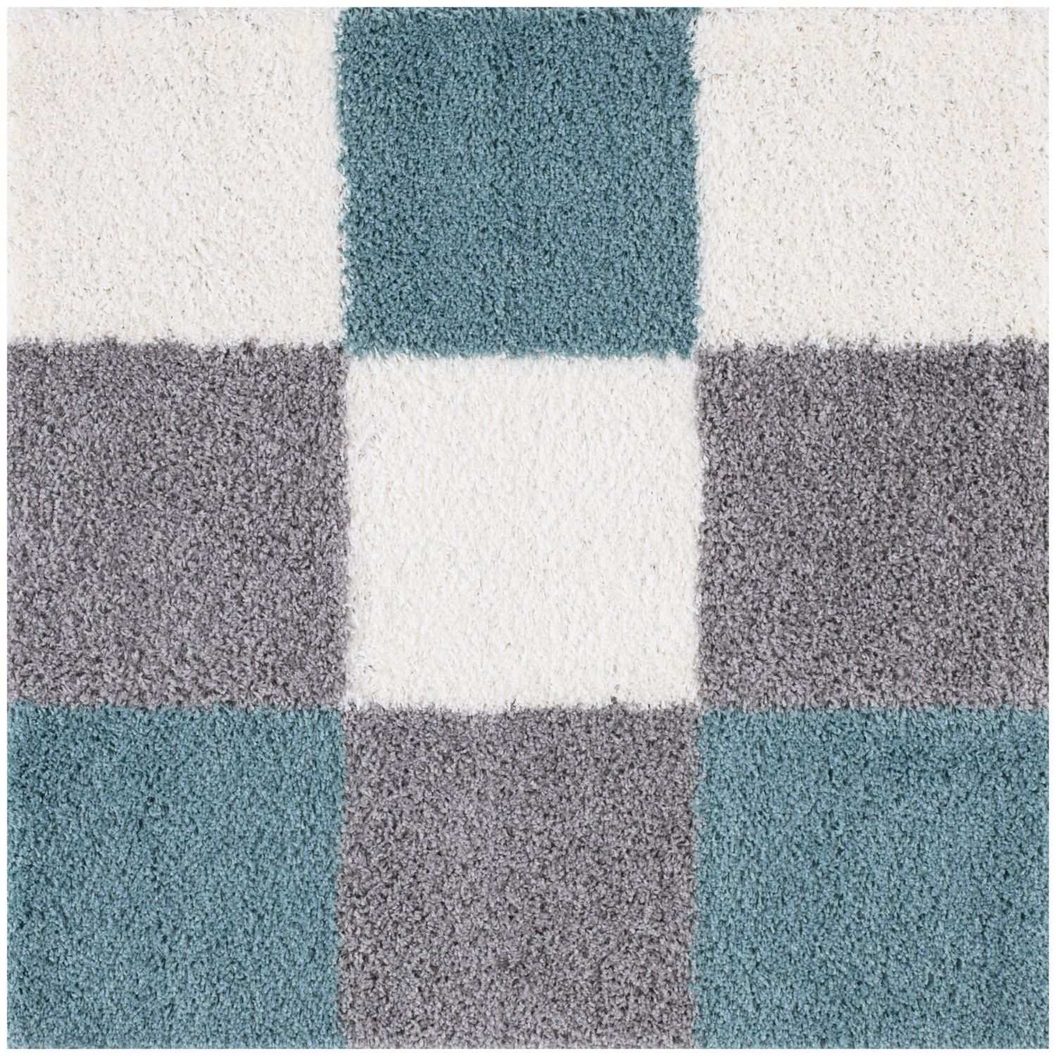 A plush shaggy area rug with a geometric pattern of duck egg blue and gray squares on a white background