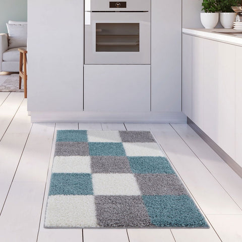 A plush shaggy area rug with a modern checkered pattern in duck egg blue gray and white perfect for cozy rooms