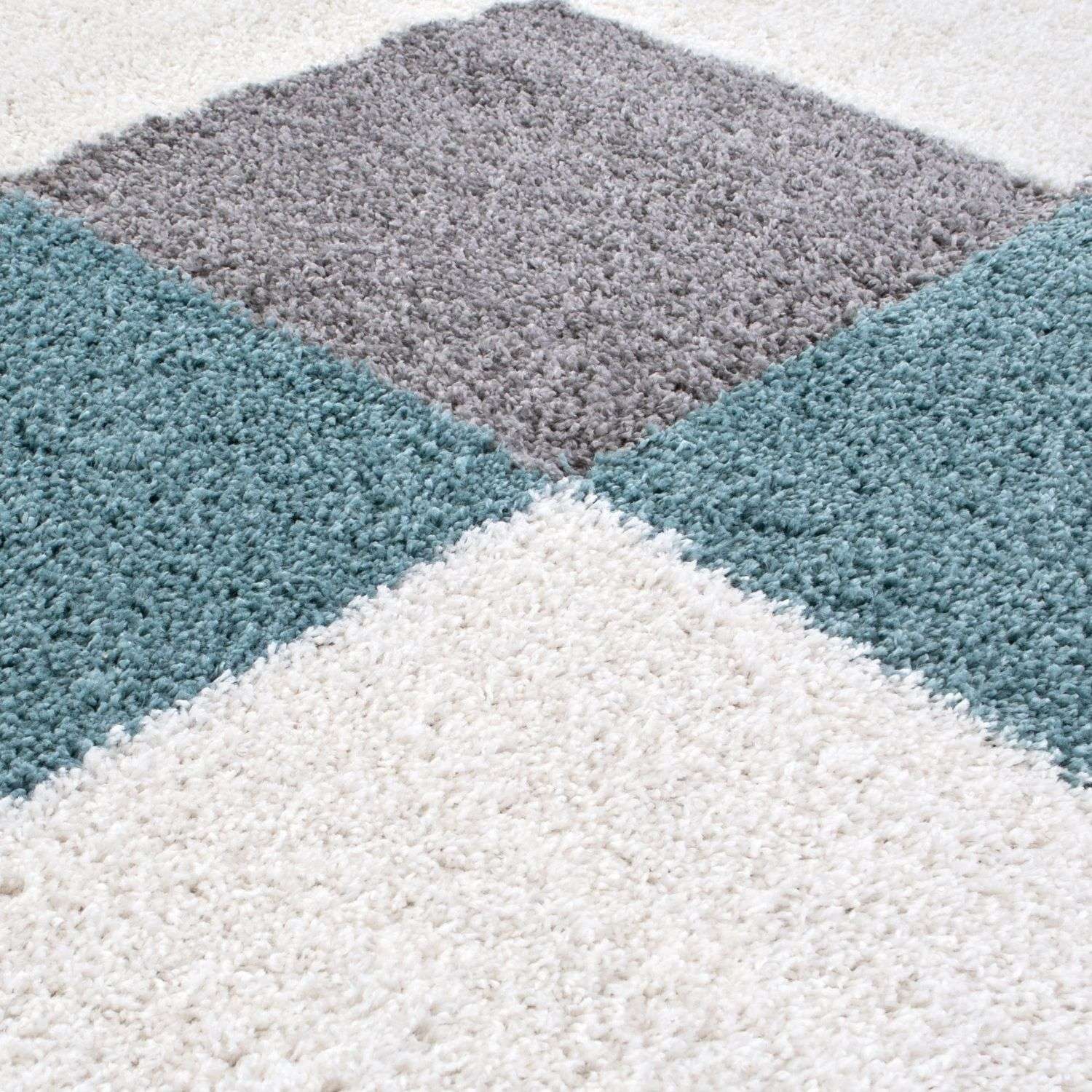 A plush shaggy rug with a geometric pattern in duck egg blue gray and white perfect for cozy spaces