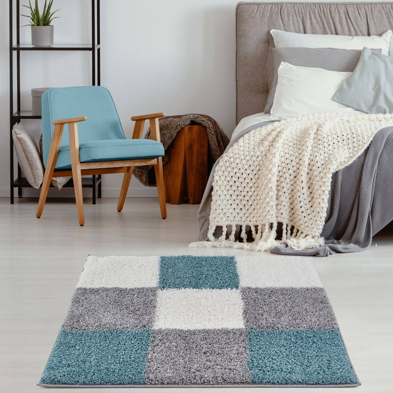 A plush square myshaggy area rug with a modern patchwork design in duck egg blue gray and white tones