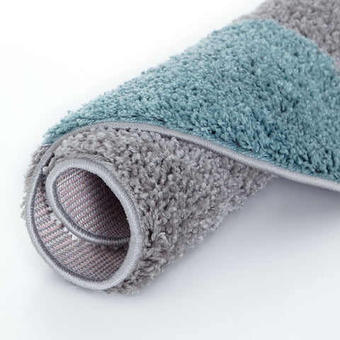 A plush two-toned myshaggy geometric rug with soft duck egg blue and gray shaggy texture and stitched edges