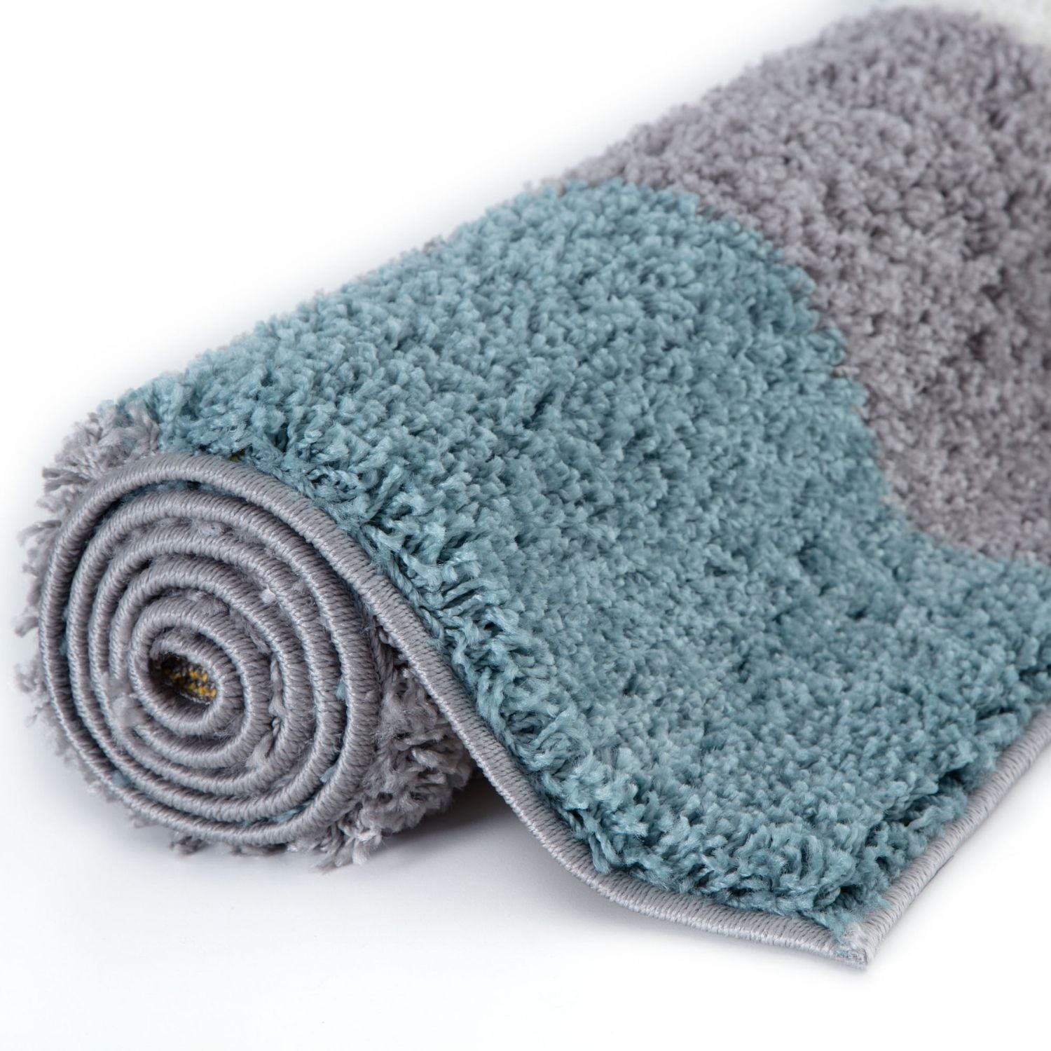 A plush two-toned shaggy rug in soft teal and duck egg blue perfect for cozy home decor