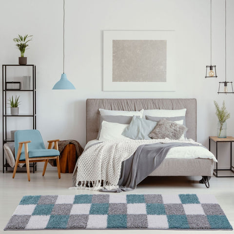 A plush rectangular Myshaggy geometric rug with a shaggy texture in duck egg blue and gray squares on white