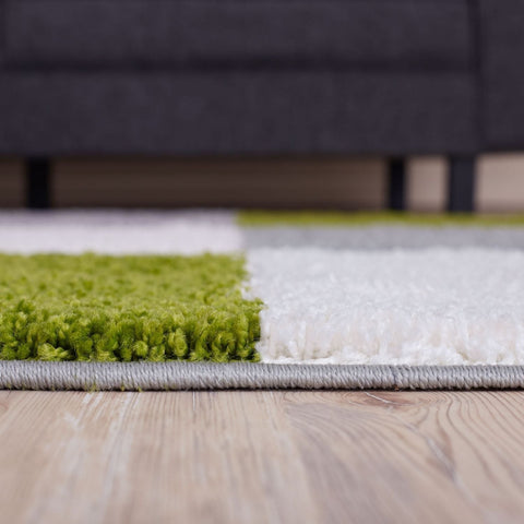 A plush myshaggy geometric green rug with vibrant lime and white blocks soft shaggy texture and gray border