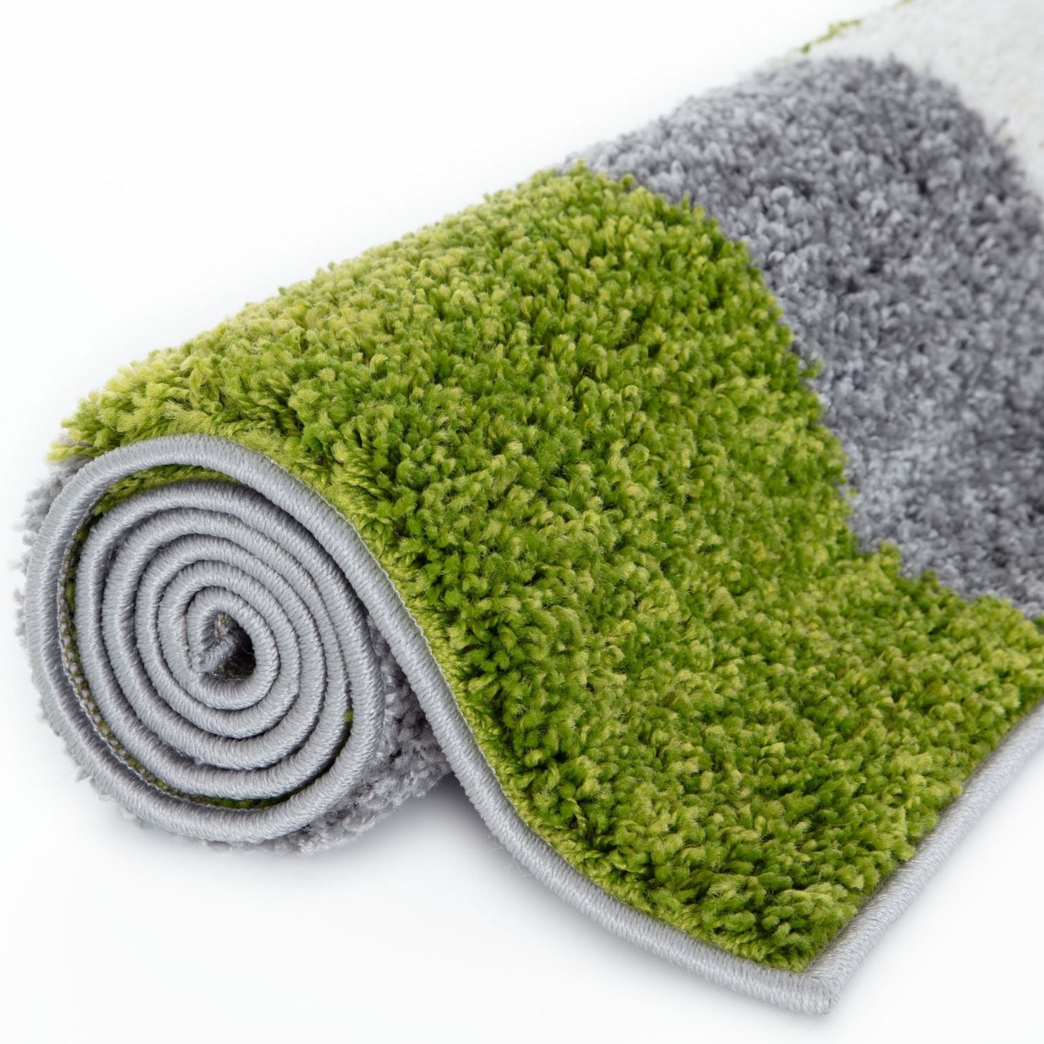 A plush myshaggy geometric green bath mat rolled up in vibrant green and soft gray colors