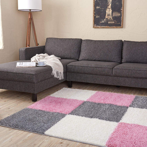 A plush shaggy area rug with a geometric pink gray and white pattern from myshaggy geometric pink collection