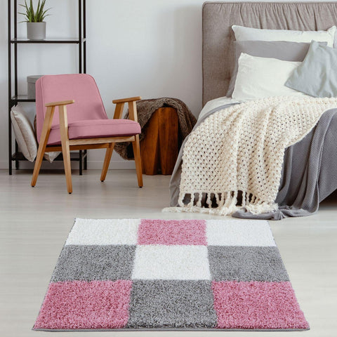A plush shaggy myshaggy geometric pink rug with a modern checkered pattern in pink white and gray tones