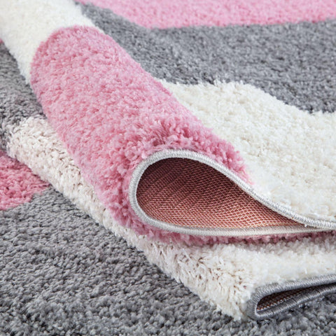 A plush soft-textured myshaggy geometric pink area rug with a striped pattern in pink gray and white