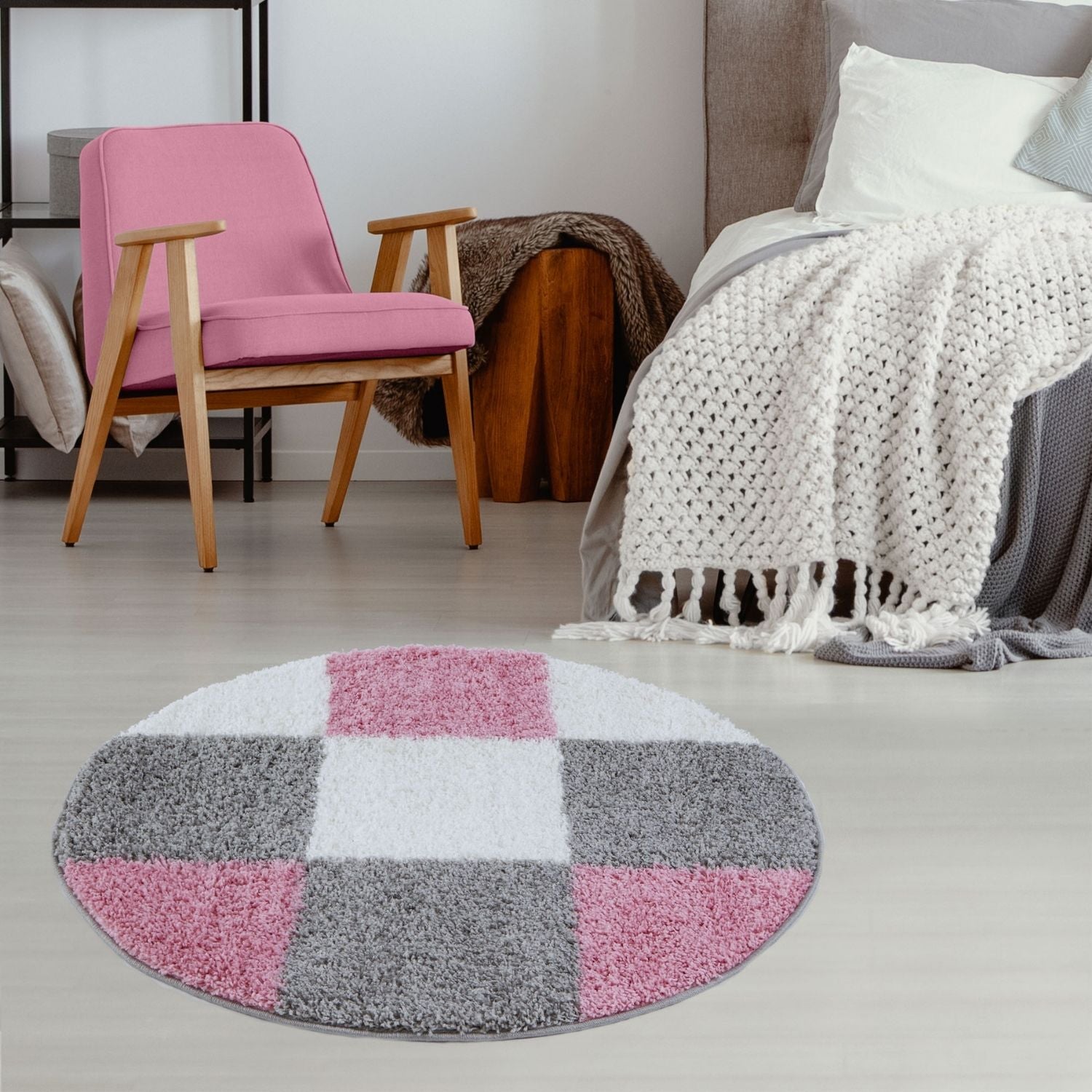 Round myshaggy geometric pink rug with plush shaggy texture in a pink white and gray checkerboard pattern