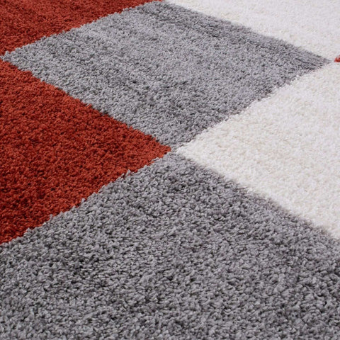 A plush high-pile myshaggy geometric terra rug with bold red gray and white geometric terra sections