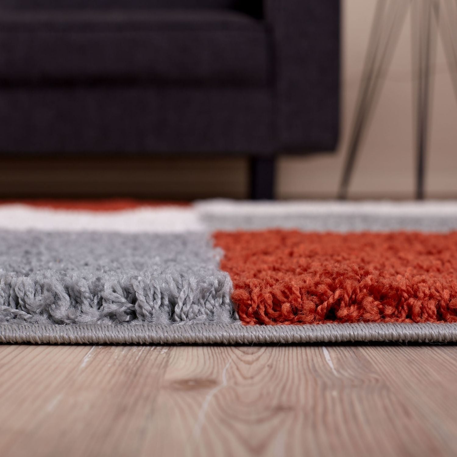 A plush modern area rug with a geometric pattern in gray and terracotta tones myshaggy geometric terra rug