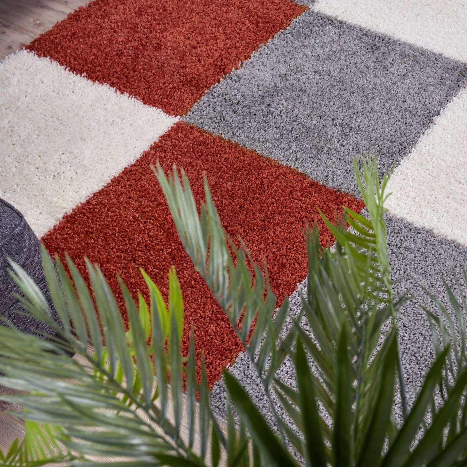 A plush shaggy area rug with rust orange gray and cream geometric squares from myshaggy geometric terra collection