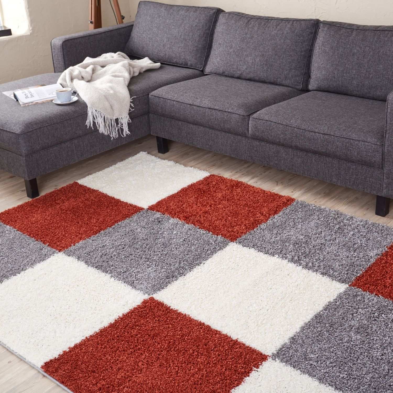 A plush shaggy area rug with a red gray and white geometric pattern perfect for cozy spaces myshaggy geometric terra