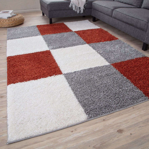 A plush shaggy area rug with a bold red white and gray geometric patchwork design called myshaggy geometric terra rug