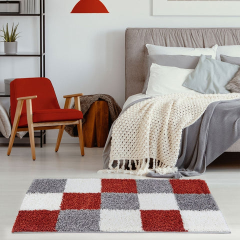 A plush shaggy myshaggy geometric terra rug with a bold red white and gray checkerboard pattern