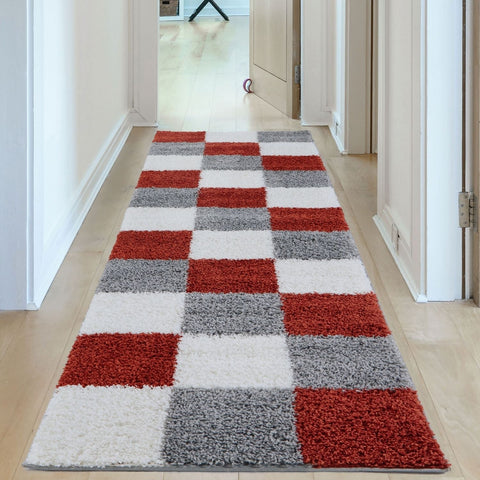 A plush shaggy runner rug from myshaggy geometric terra with bold red white and gray checkered pattern