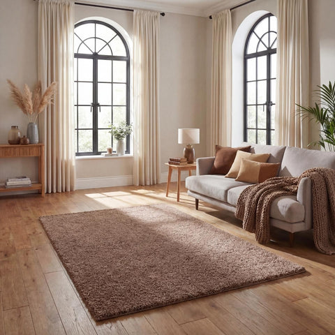 A plush myshaggy solid beige rug with a soft, textured surface lies on a wooden floor as an earthy brown rug