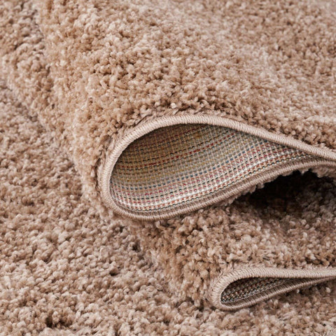 Beige rug myshaggy solid beige features a plush shaggy textured looped pile with a durable woven backing