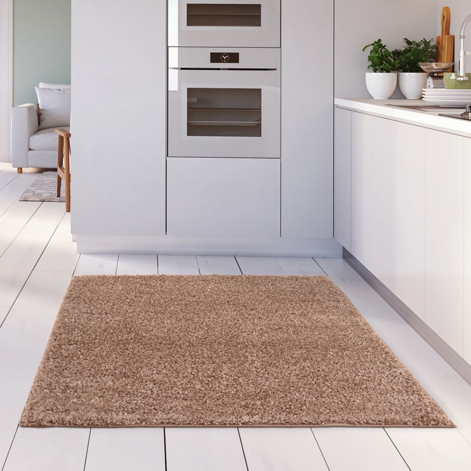 A plush myshaggy solid beige rug with soft shaggy texture on a white wooden floor a cozy beige rug option