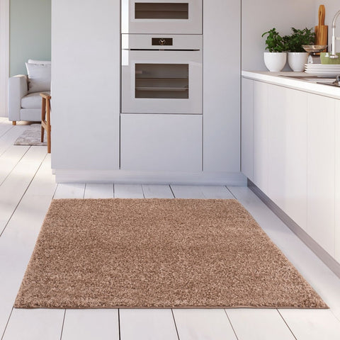 A plush myshaggy solid beige rug with soft shaggy texture on a white wooden floor a cozy beige rug option