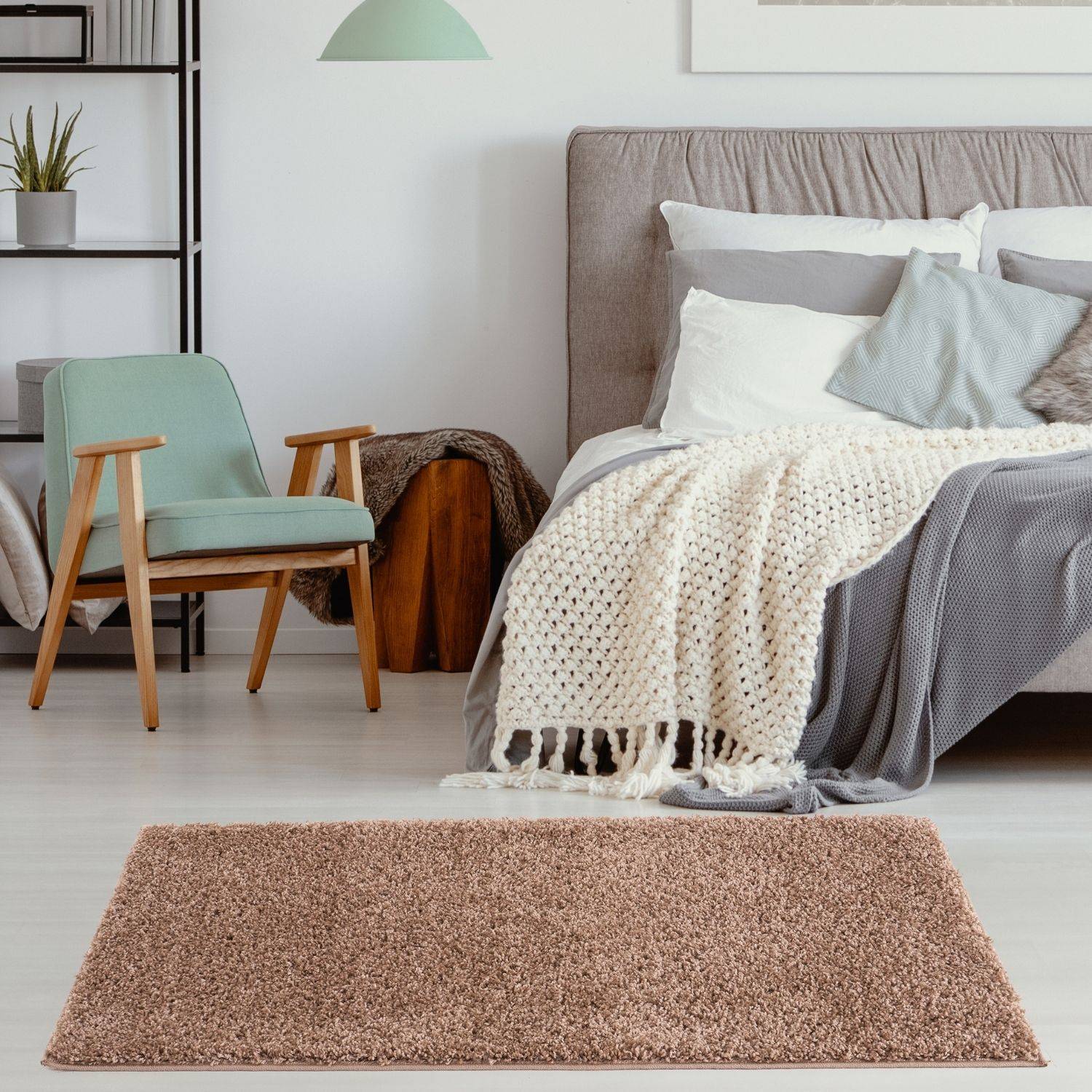 A plush taupe-colored shag rug with a soft textured surface perfect as a myshaggy solid beige rug or beige rug option