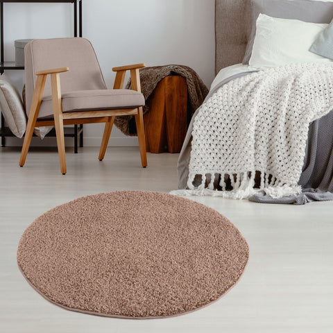 A round plush myshaggy solid beige rug with a soft shaggy texture perfect as a cozy solid beige rug for any room