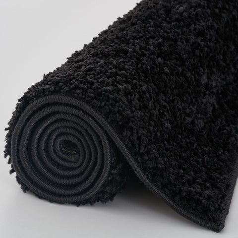 Black plush bath mat from myshaggy solid black rug with dense shaggy texture and rolled edge solid black rug