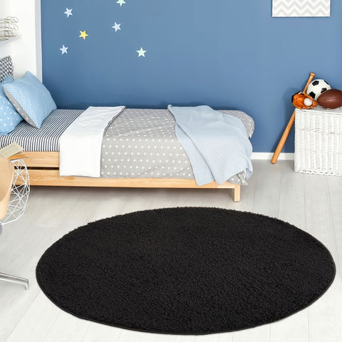 Black round plush rug from myshaggy solid black collection perfect as a cozy solid black rug for any room