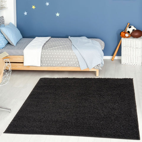 Black shaggy rectangular rug showcasing the myshaggy solid black rug as a soft solid black rug for cozy decor