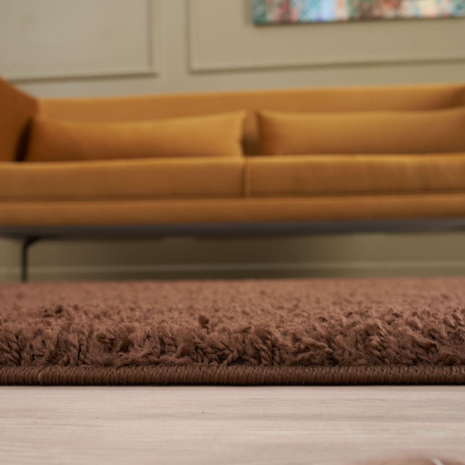 A plush myshaggy solid brown rug with a dense soft pile and neatly stitched border perfect as a brown rug