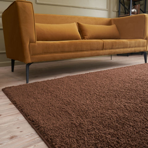 A plush myshaggy solid brown rug with a soft textured surface perfect as a cozy brown rug for any room